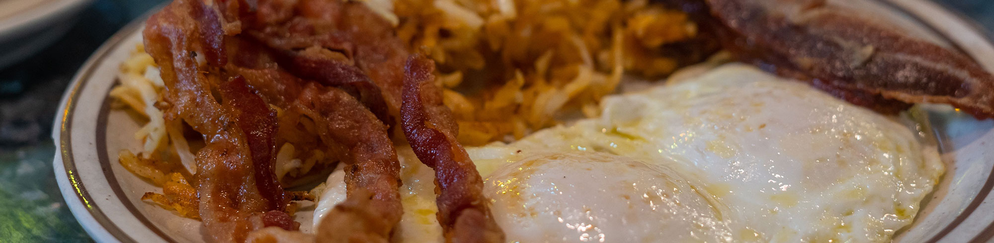 Eggs, bacon, and hash browns on a plate